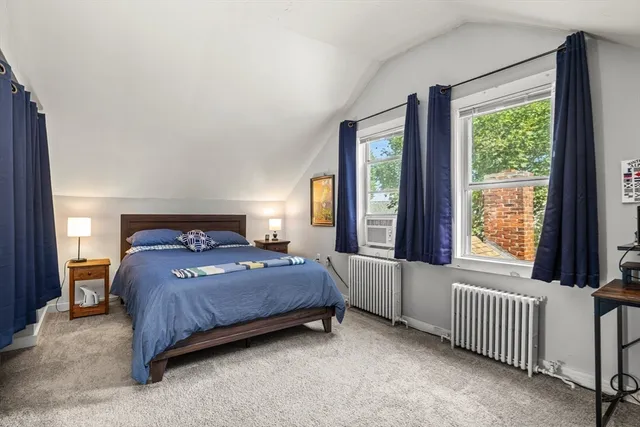 a bedroom with a bed and a table