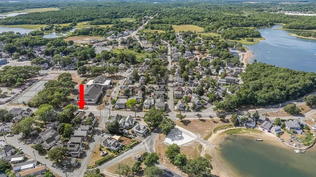 an aerial view of residential houses with outdoor space and river
