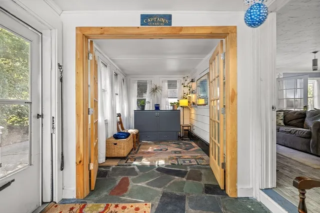 a view of a dining room and livingroom with furniture wooden floor and a rug