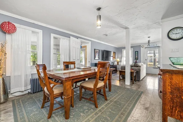 a view of a dining room with furniture window and wooden floor