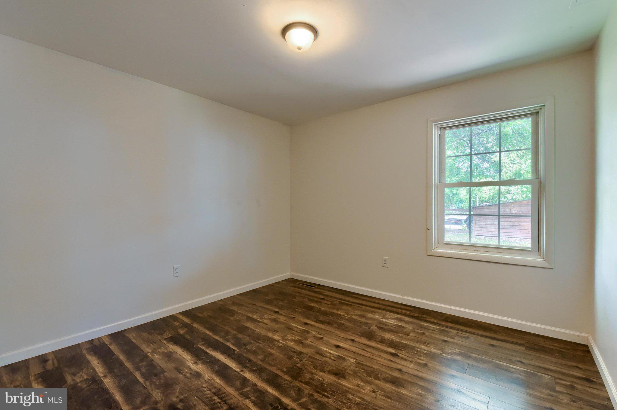 3740 Beagle Road Middletown, PA 17057 - Photo 15 of 70 an empty room with wooden floor and windows
