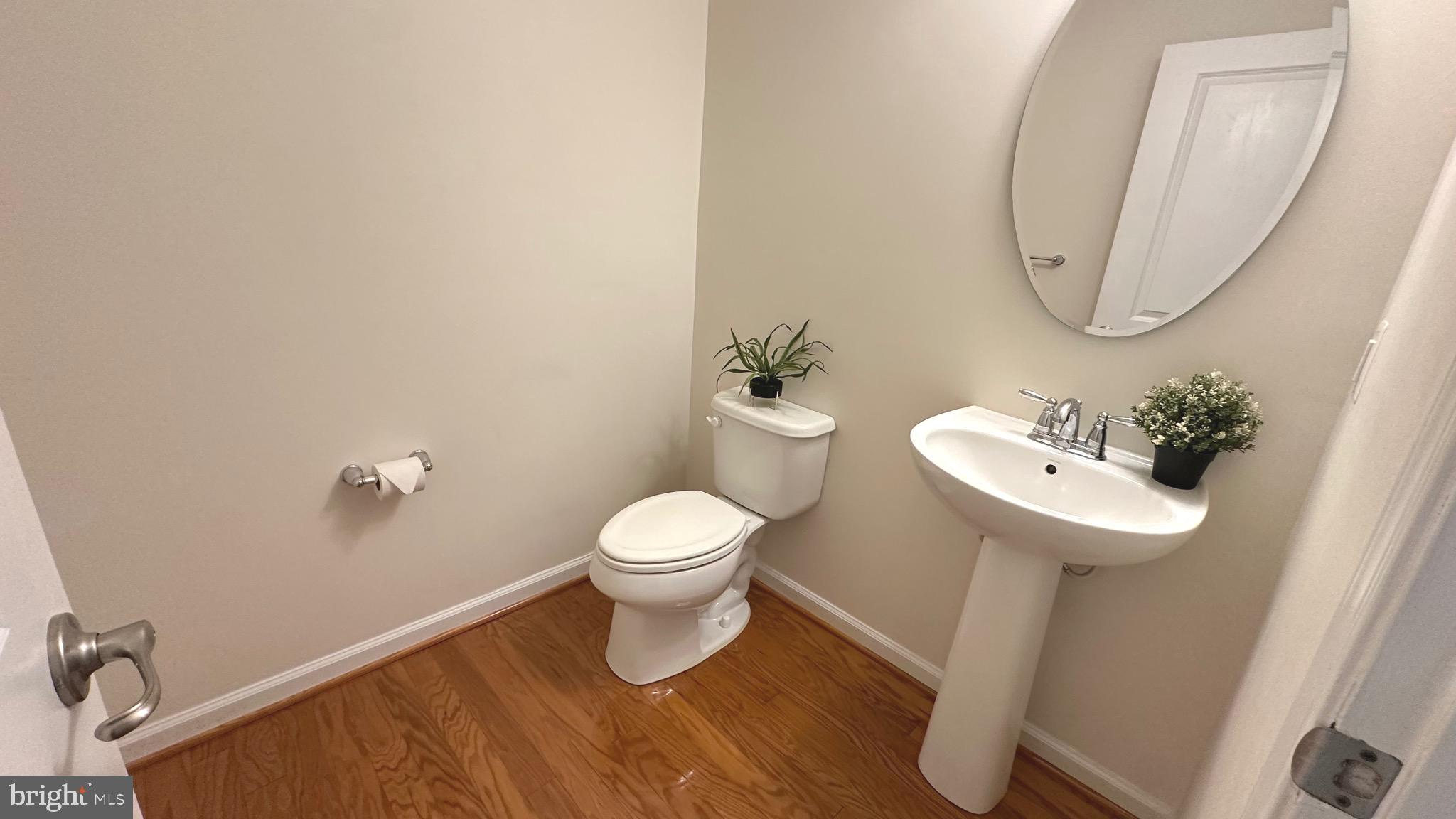 7343 Old Calvary Road Hanover, MD 21076 - Photo 12 of 35 a white toilet sitting next to a bathroom sink