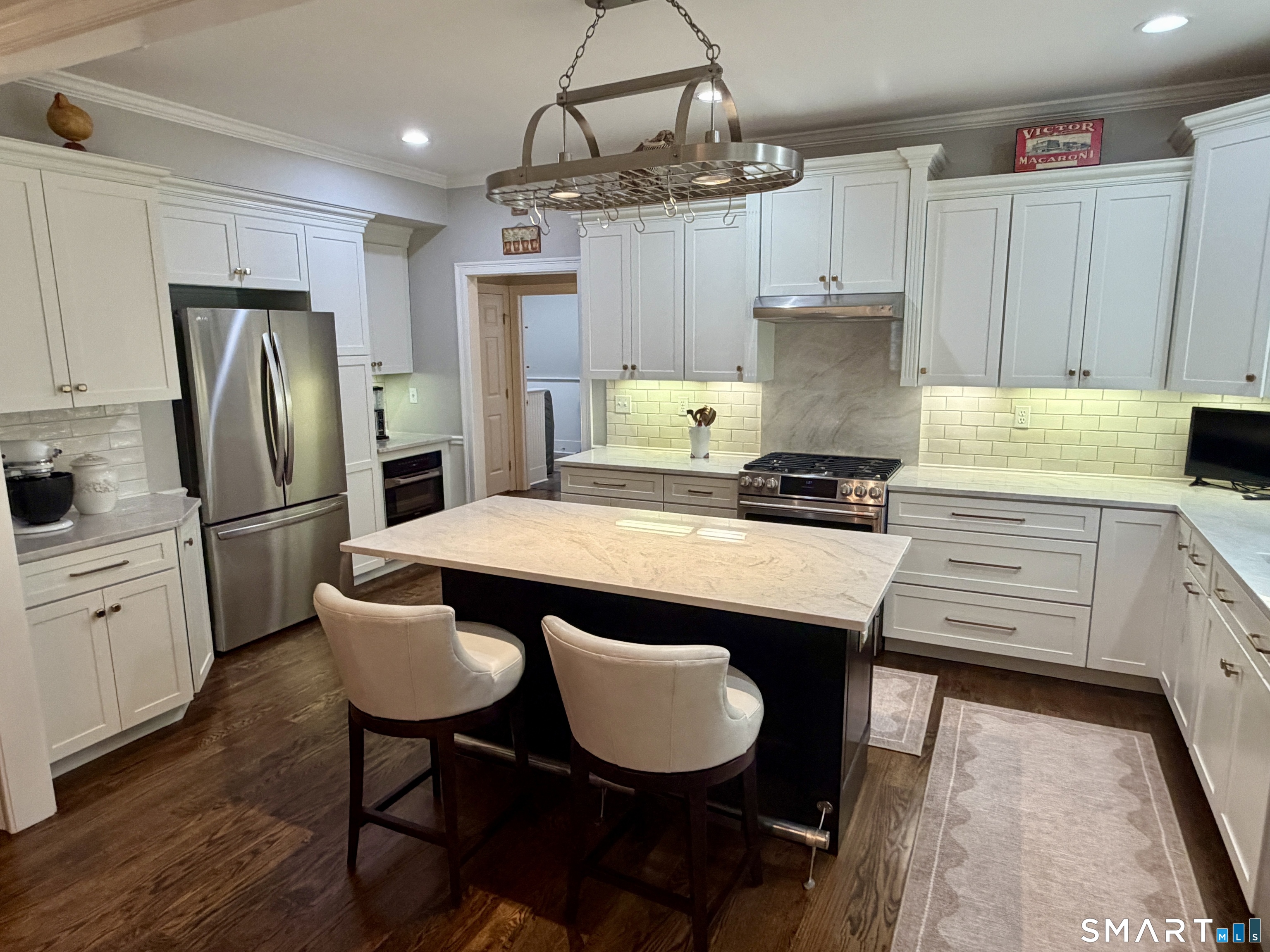 6 Winding Way, Unit 6 Trumbull, CT 06611 - Photo 13 of 37 a kitchen with stainless steel appliances a dining table a stove a refrigerator and cabinets