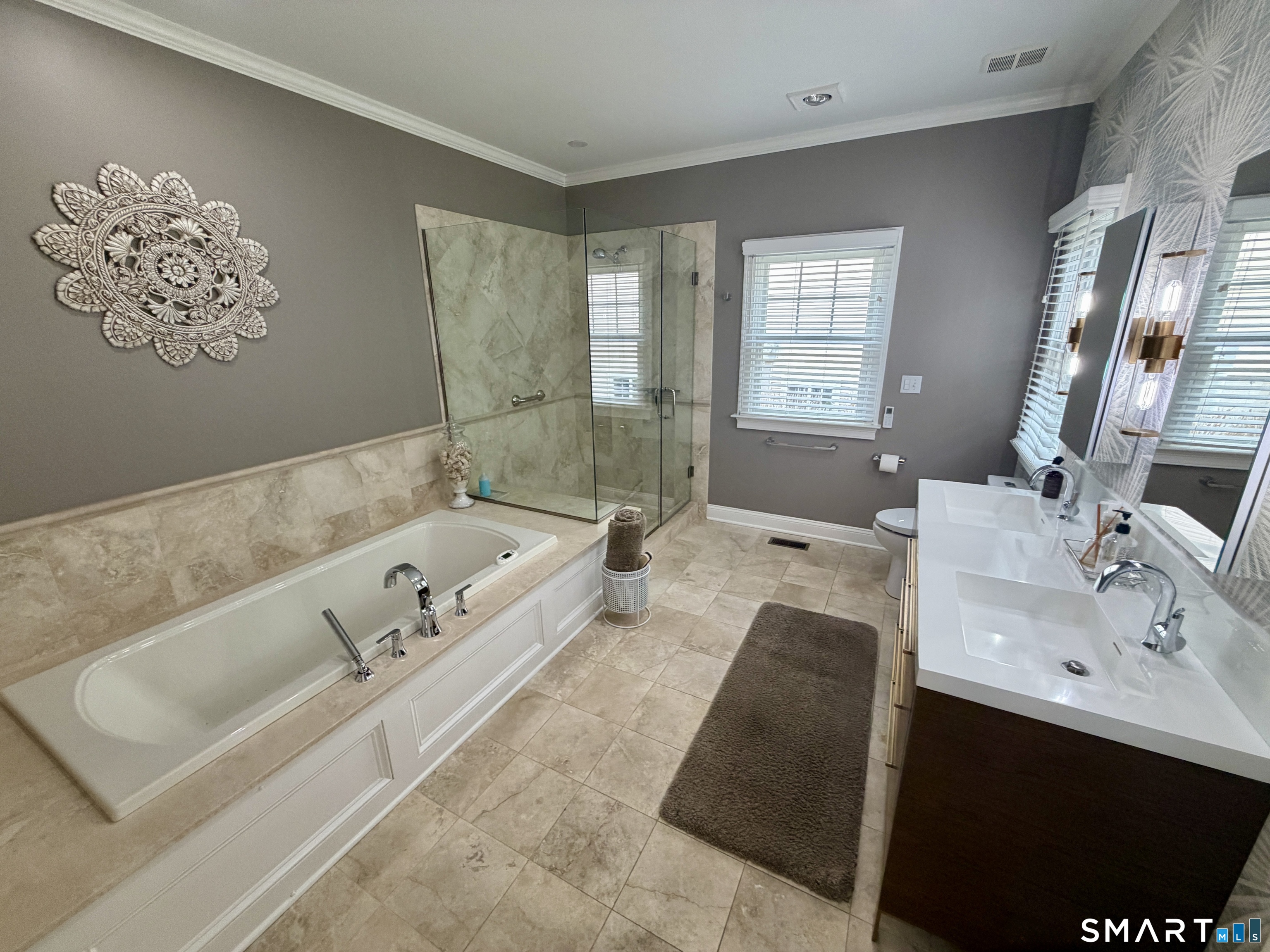 6 Winding Way, Unit 6 Trumbull, CT 06611 - Photo 17 of 37 a bath tub sitting next to a bathroom sink and a mirror