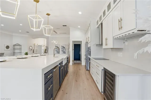 a large kitchen with stainless steel appliances lots of counter space and a sink