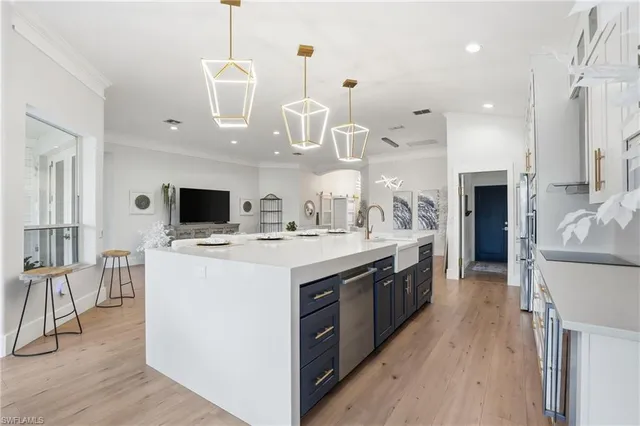 a large kitchen with stainless steel appliances kitchen island granite countertop a stove and a view of living room