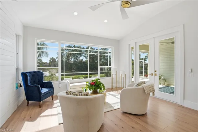 a living room with furniture and a potted plant