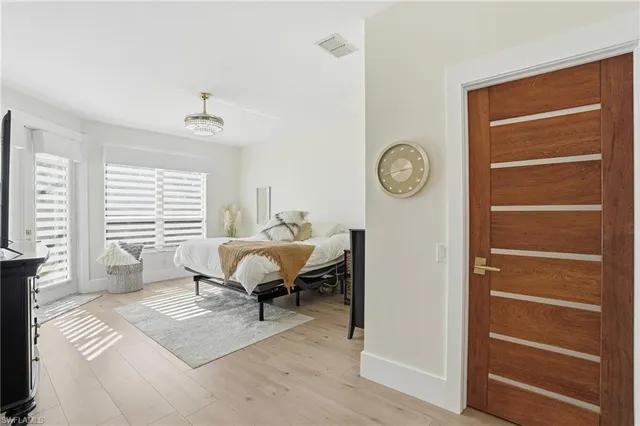 a spacious bedroom with a bed and a window