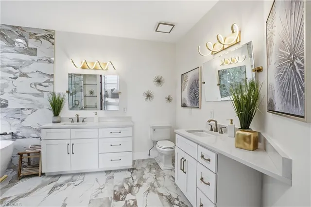 a spacious bathroom with a double vanity sink mirror and
