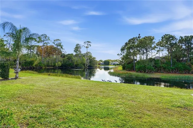 a view of a lake with a house in the background