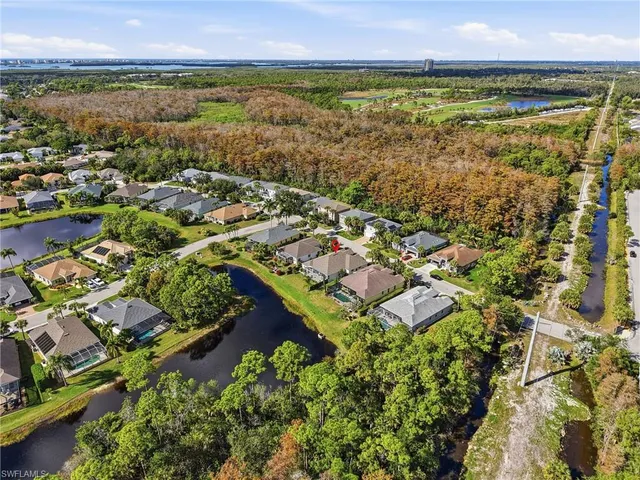 an aerial view of residential building and lake