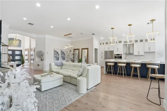 a living room with furniture and a kitchen view