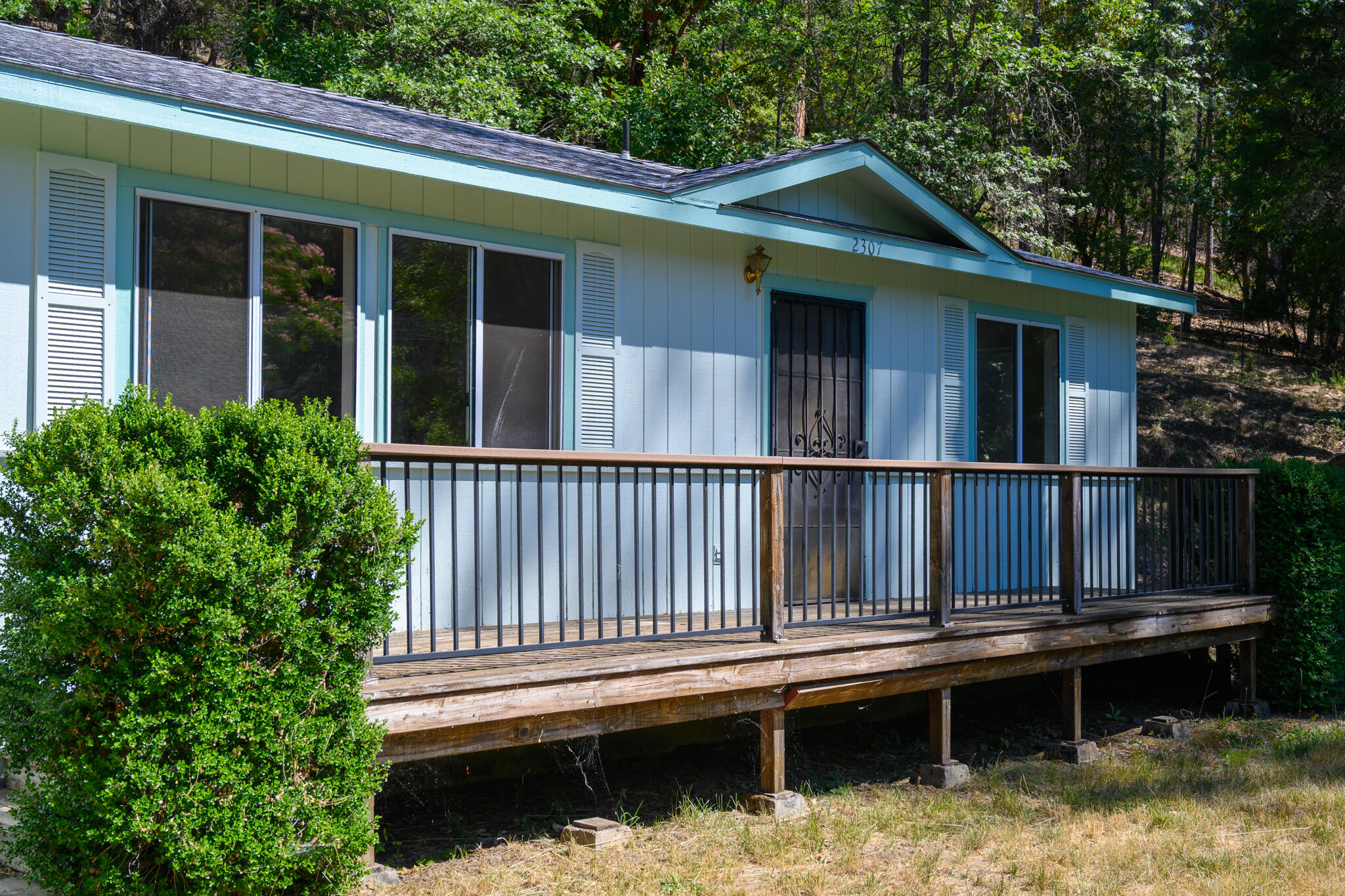 a balcony with wooden floor and fence