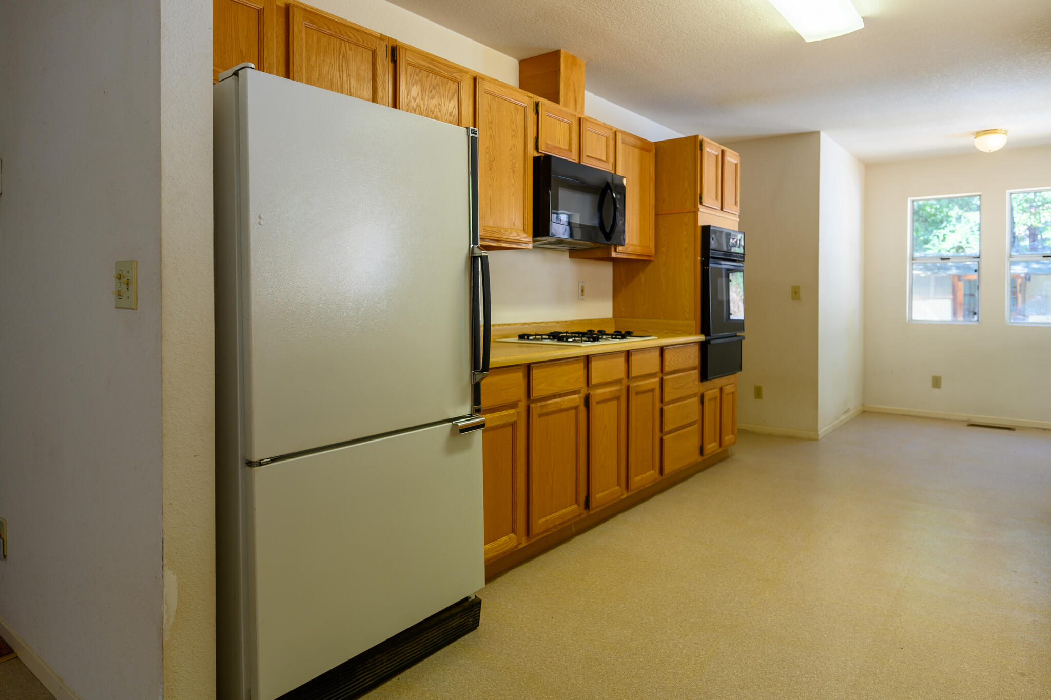 2307 Goose Ranch Road Lewiston, CA 96052 - Photo 16 of 37 a kitchen with stainless steel appliances a refrigerator a stove a microwave a sink and cabinets