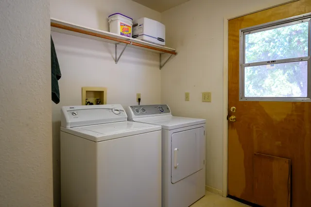 a view of a storage & utility room with a refrigerator