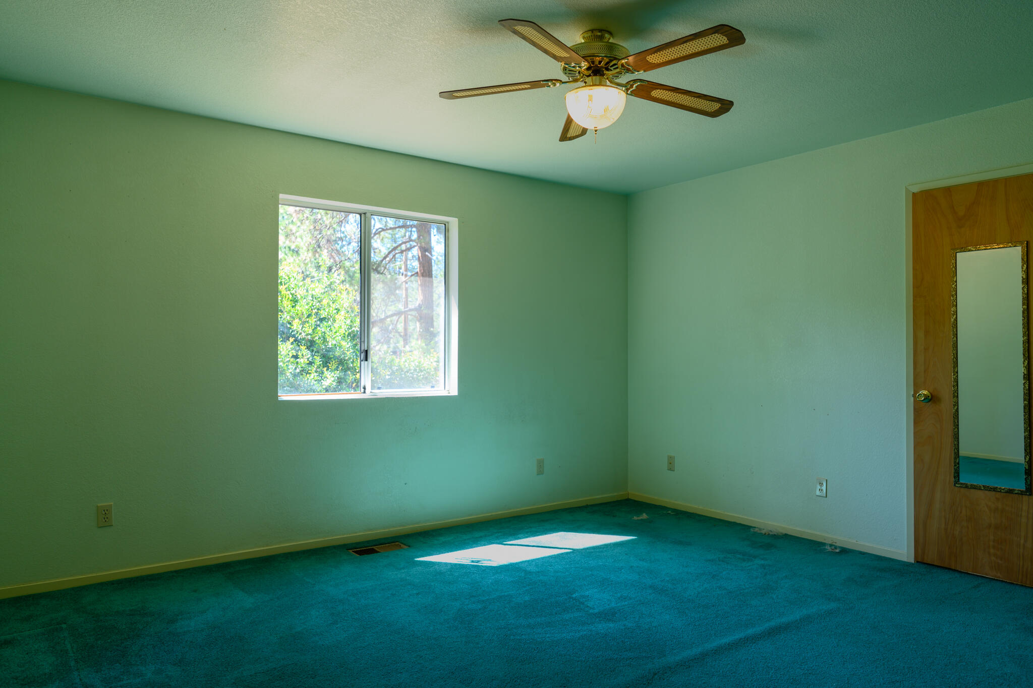 2307 Goose Ranch Road Lewiston, CA 96052 - Photo 7 of 37 an empty room with a window and a fan