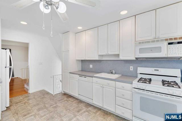 516 Knickerbocker Road Cresskill, NJ 07626 - Photo 8 of 31 a view of cabinets a sink dishwasher and a stove in a kitchen