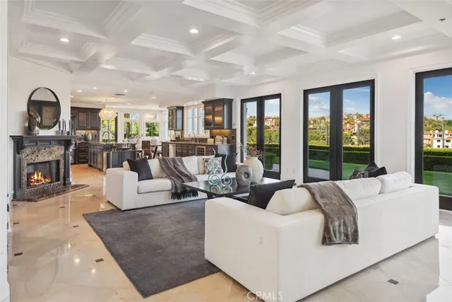 a living room with furniture a large window and a fireplace