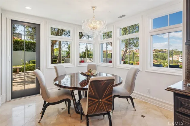 a view of a hallway to a livingroom and dining room with furniture