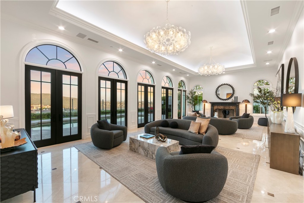 28 Shoreridge Newport Coast, CA 92657 - Photo 5 of 75 Formal Living Room at Twilight with views to the pool. Curated paint colors, light fixtures and furniture placement that create unique individuality and greatness.