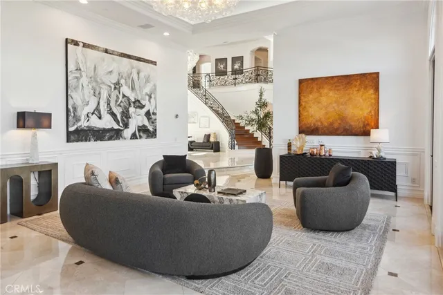 a living room with furniture kitchen view and a large window