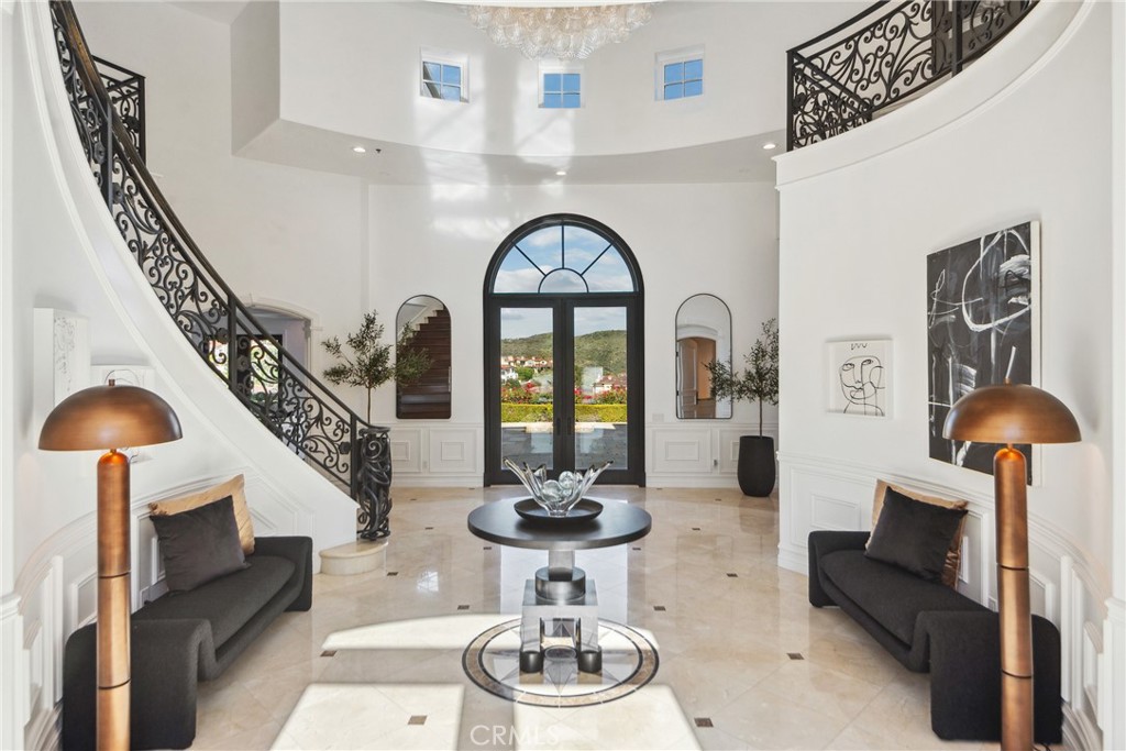 28 Shoreridge Newport Coast, CA 92657 - Photo 10 of 75 The formal marbled entry with curated paint and lighting describes the lifestyle statement of this iconic estate.