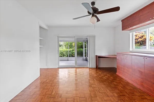 a view of room with ceiling fan and window