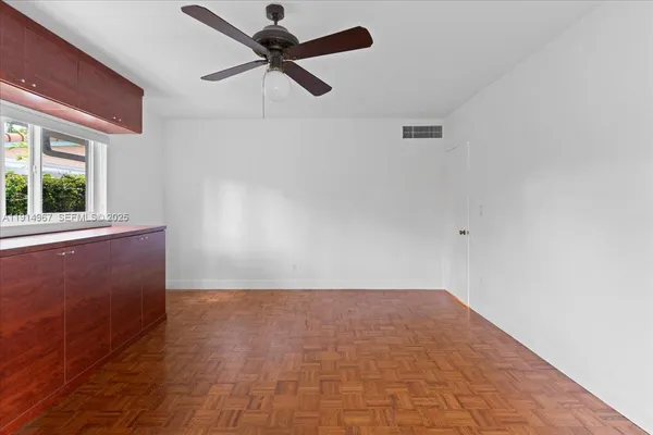 an empty room with a empty space and a ceiling fan