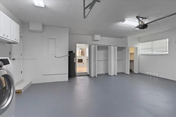 a view of a storage & utility room with refrigerator washer and dryer