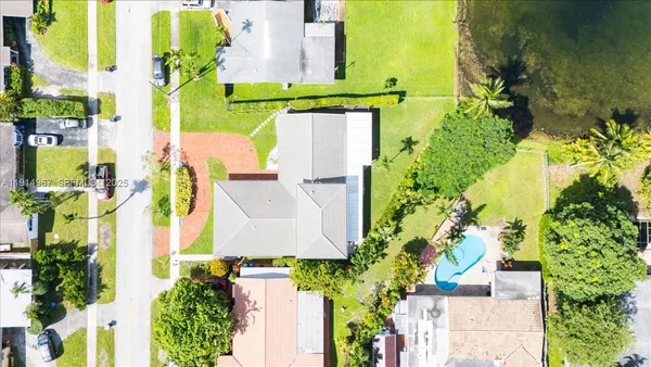 an aerial view of residential house with outdoor space and swimming pool