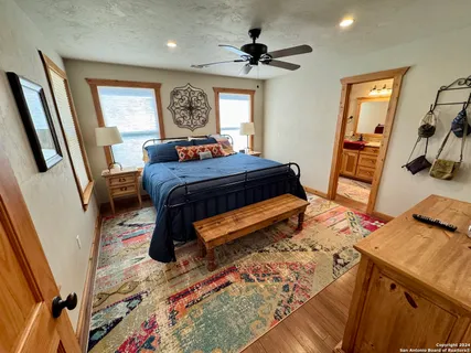 a bedroom with a bed and a mirror on the dresser