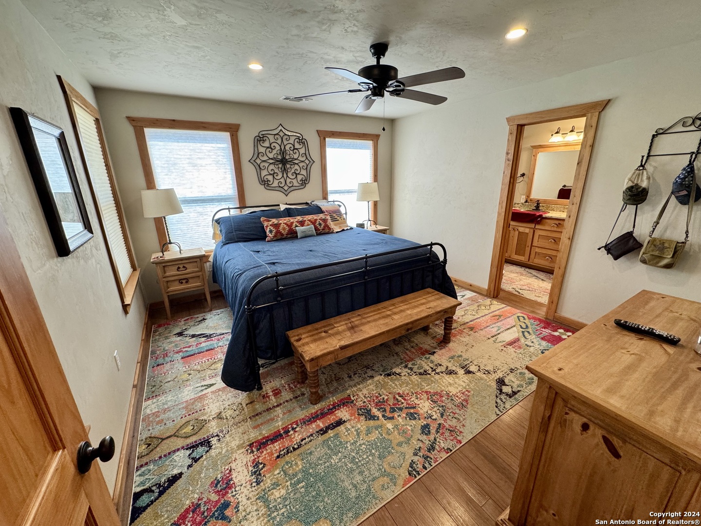 174 West 12 Mile Crossing Road Ingram, TX 78025 - Photo 7 of 13 a bedroom with a bed and a mirror on the dresser
