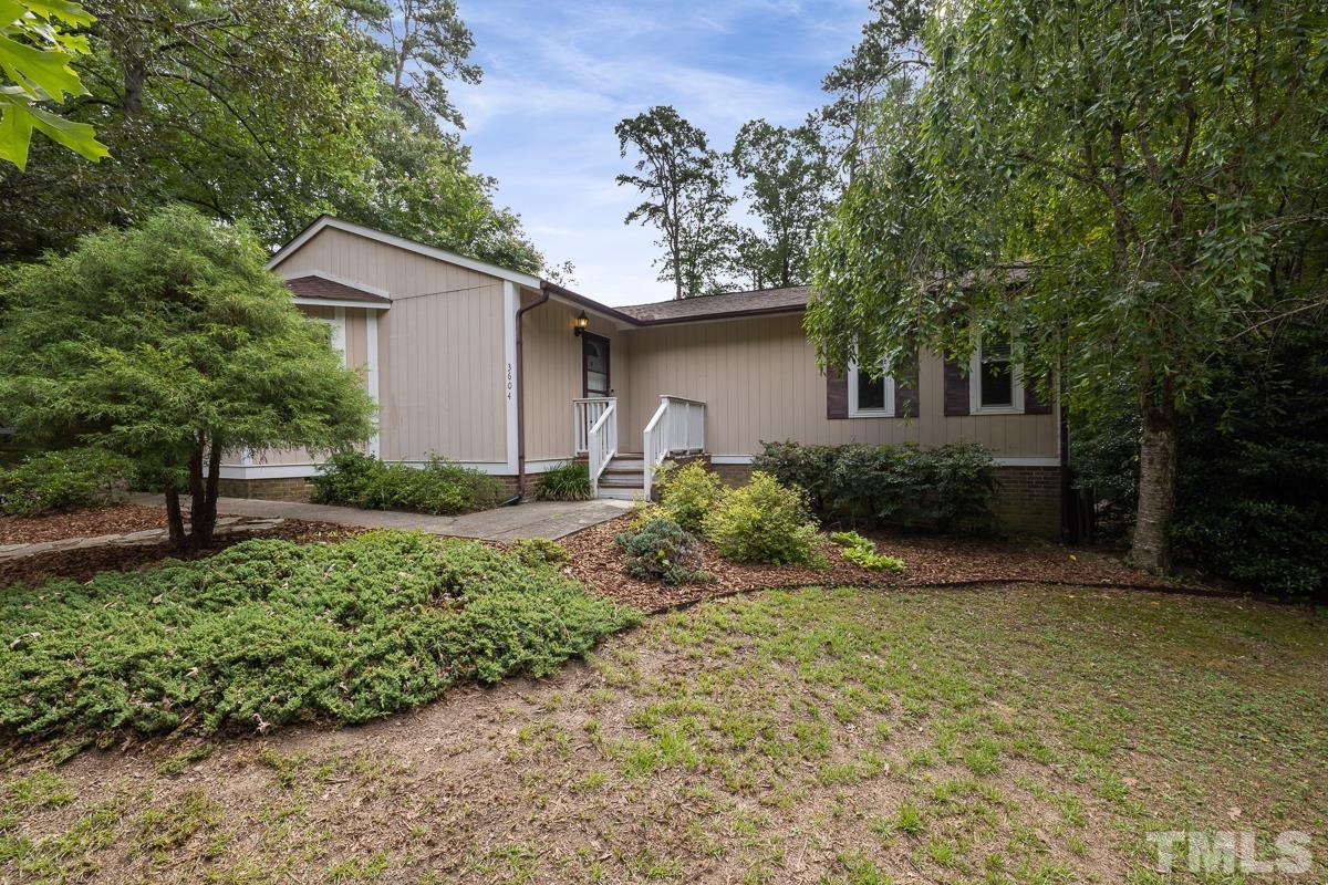 3604 Star Trek Court Raleigh, NC 27604 - Photo 1 of 24 a front view of a house with a yard and garage