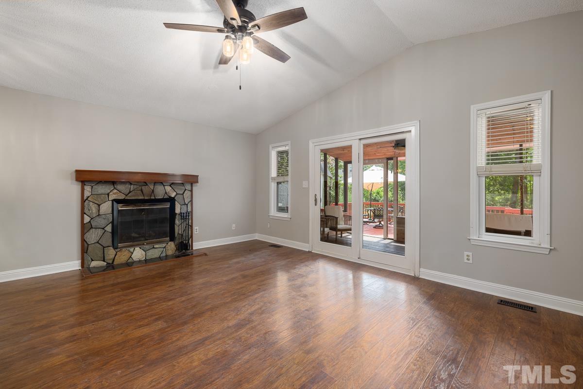 3604 Star Trek Court Raleigh, NC 27604 - Photo 11 of 24 a view of an empty room with wooden floor fireplace and a window