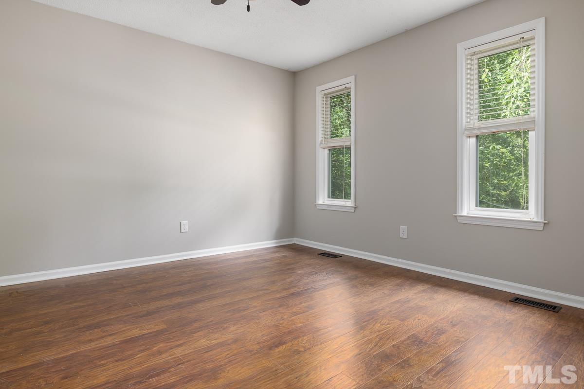 3604 Star Trek Court Raleigh, NC 27604 - Photo 12 of 24 a view of an empty room with wooden floor and a window