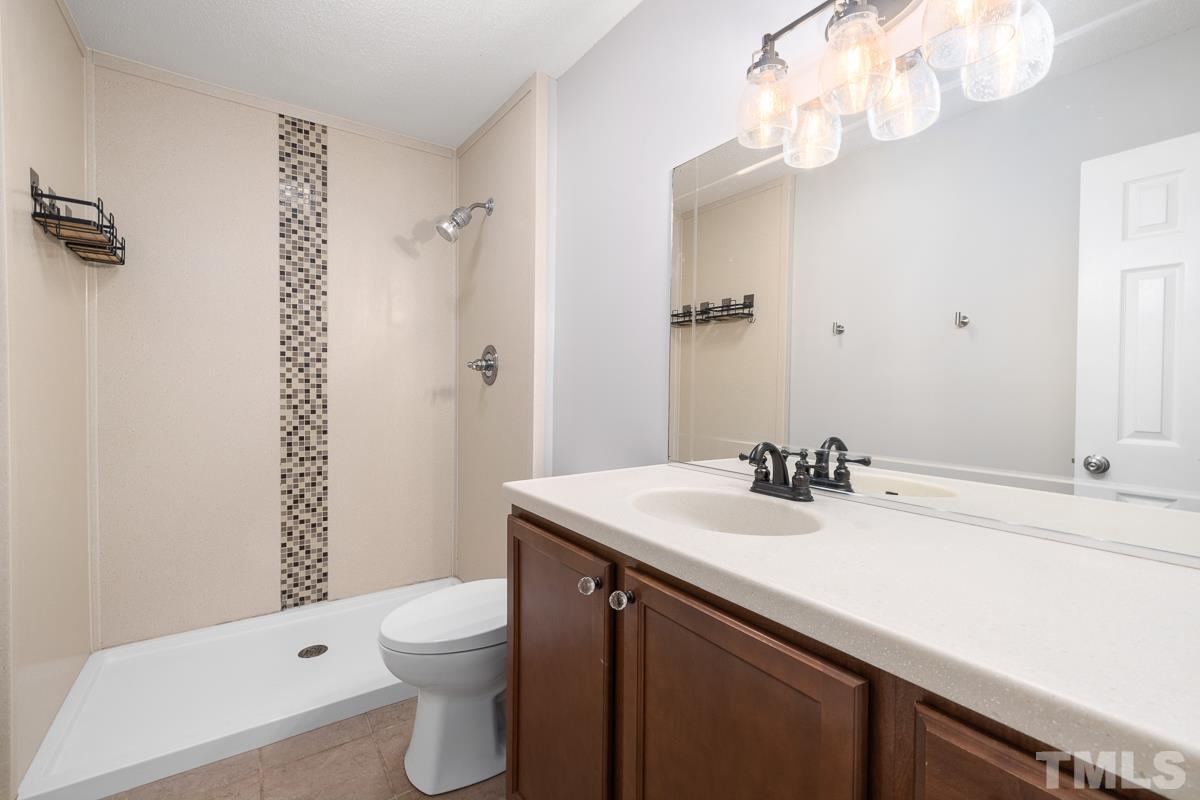 3604 Star Trek Court Raleigh, NC 27604 - Photo 14 of 24 a bathroom with a sink a toilet and shower