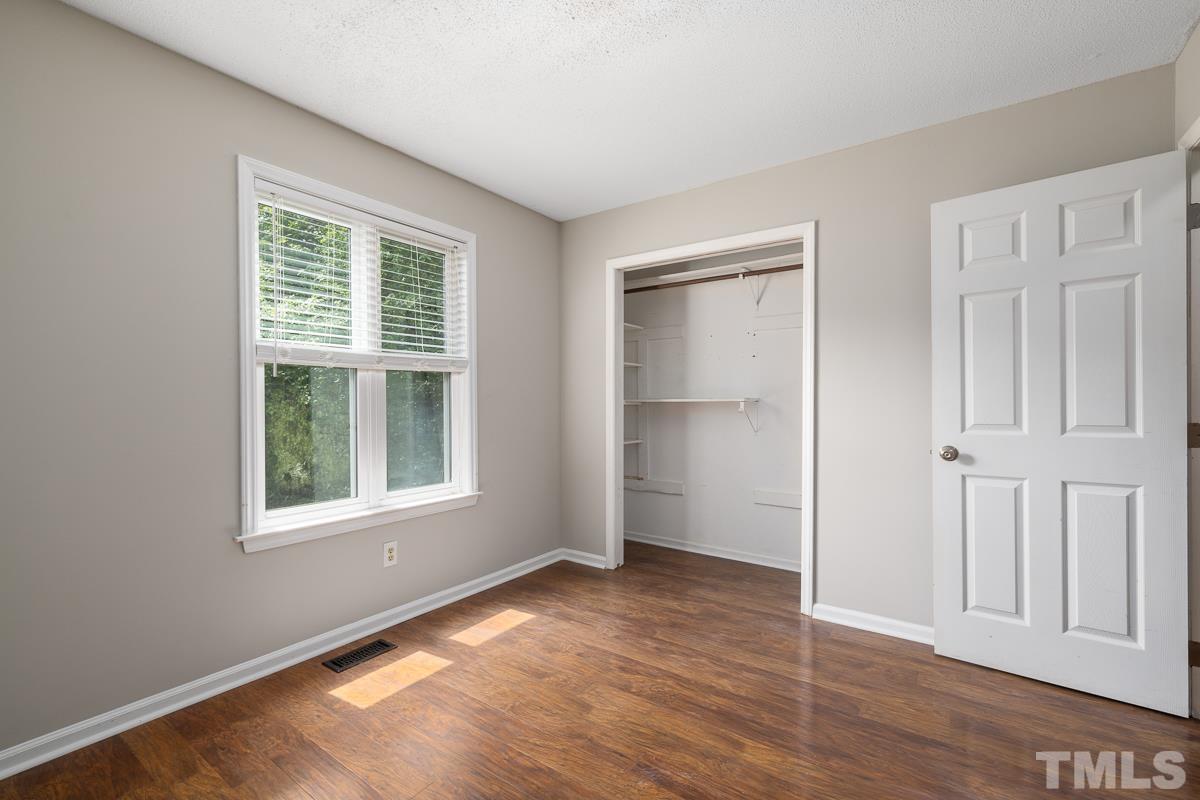 3604 Star Trek Court Raleigh, NC 27604 - Photo 15 of 24 an empty room with wooden floor closet and windows