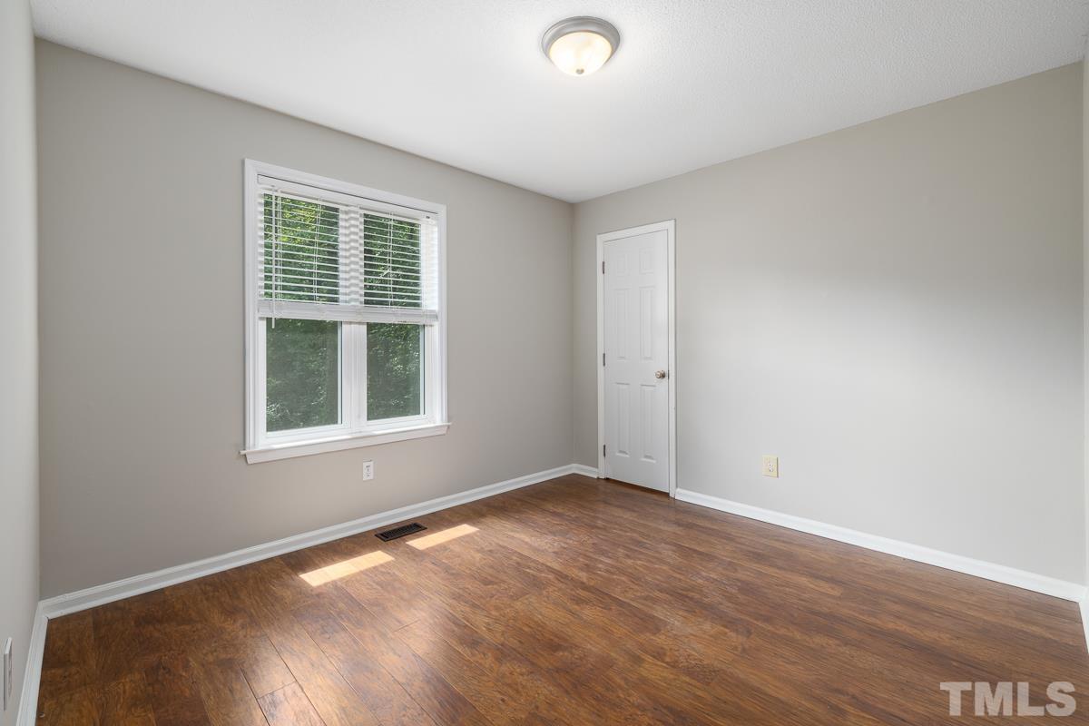3604 Star Trek Court Raleigh, NC 27604 - Photo 16 of 24 an empty room with wooden floor and windows