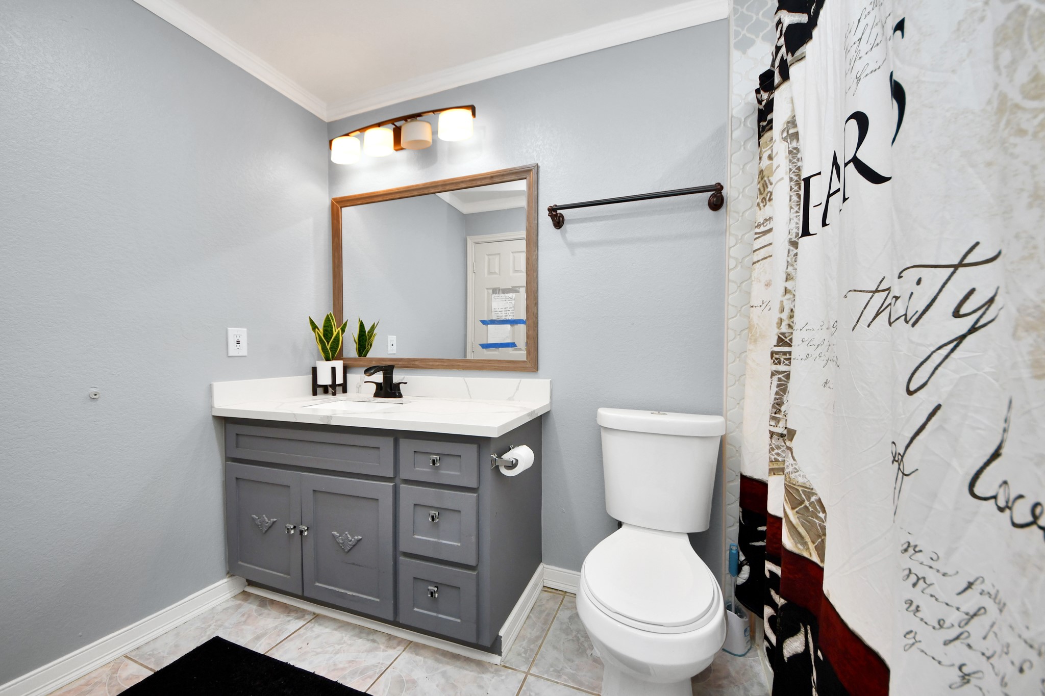1359 Littleport Lane Channelview, TX 77530 - Photo 13 of 32 a bathroom with a granite countertop toilet sink and a mirror