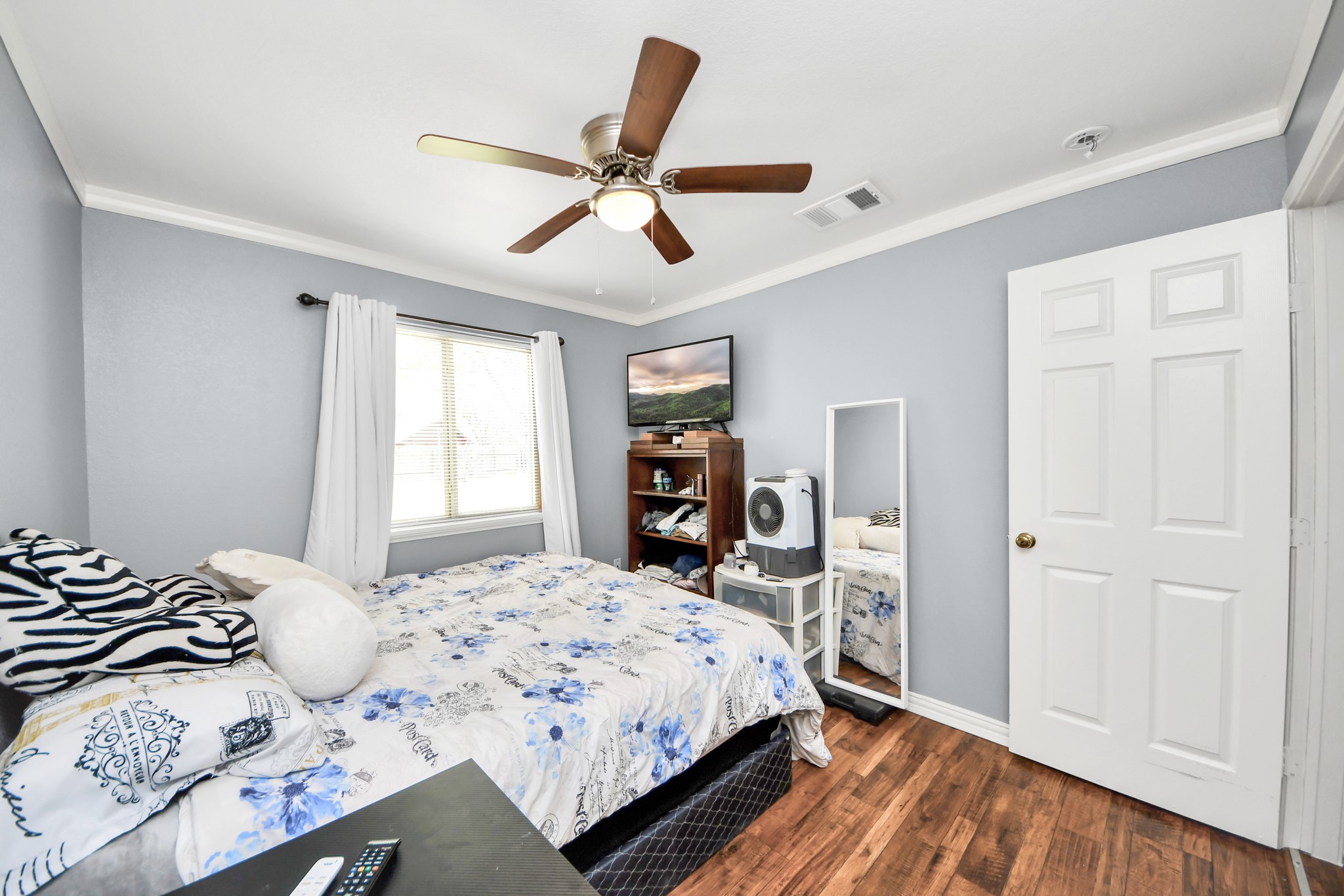 1359 Littleport Lane Channelview, TX 77530 - Photo 15 of 32 a bedroom with a large bed and a chandelier