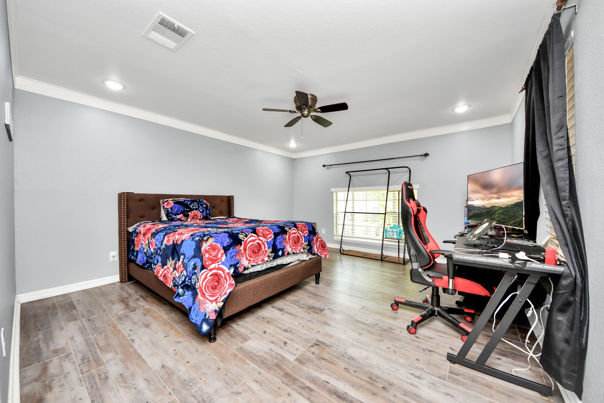 1359 Littleport Lane Channelview, TX 77530 - Photo 19 of 32 a bedroom with a bed and a chandelier