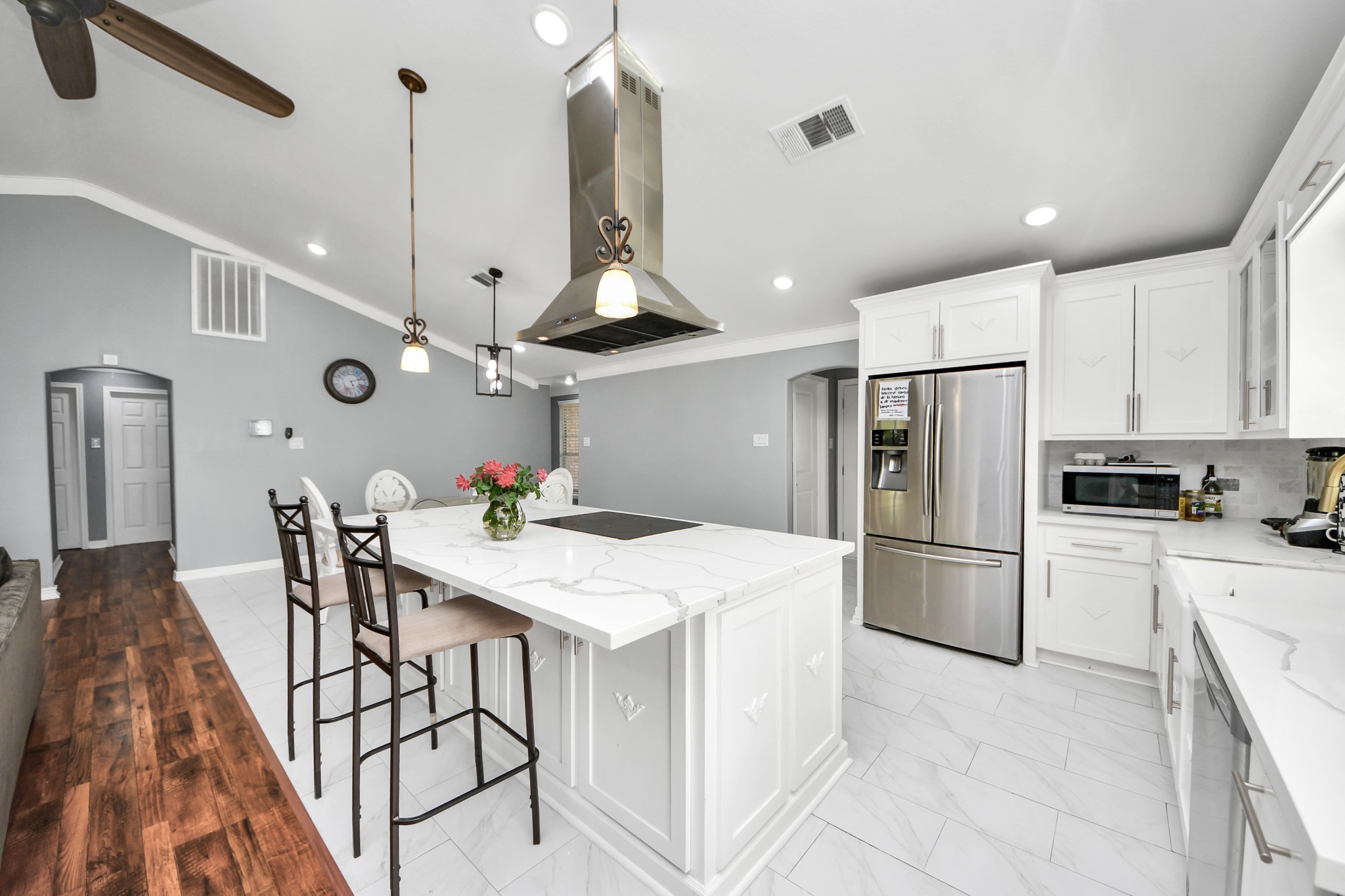 1359 Littleport Lane Channelview, TX 77530 - Photo 5 of 32 a kitchen with stainless steel appliances kitchen island a table chairs and a refrigerator