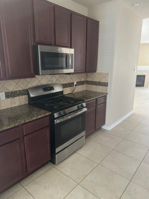 2529 Magnolia Fair Way Spring, TX 77386 - Photo 8 of 32 Beautiful kitchen with wood cabinets and stainless steel/black appliances.