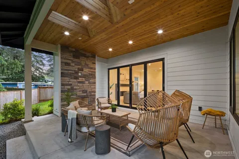 a view of a patio with a dining table and chairs with wooden floor