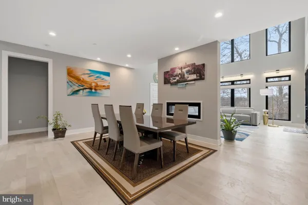 a large kitchen with kitchen island a large counter space a large window and stainless steel appliances