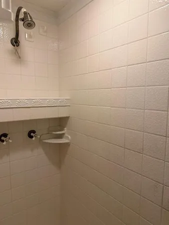 a bathroom with a sink a mirror and bathtub