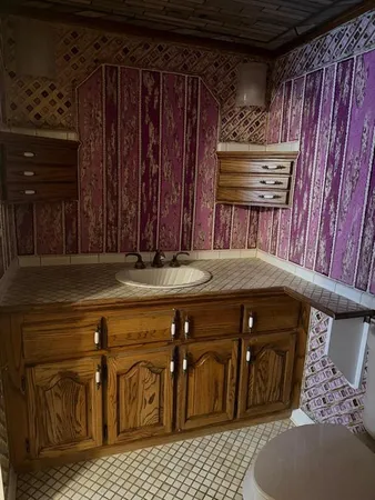 a room with a walk in closet and wooden floor