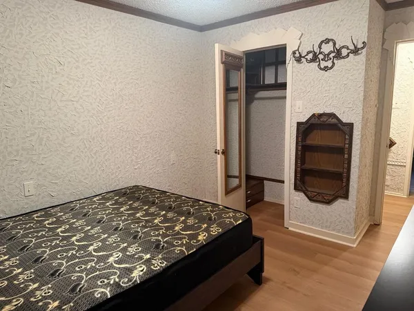 a bedroom with a bed and a mirror