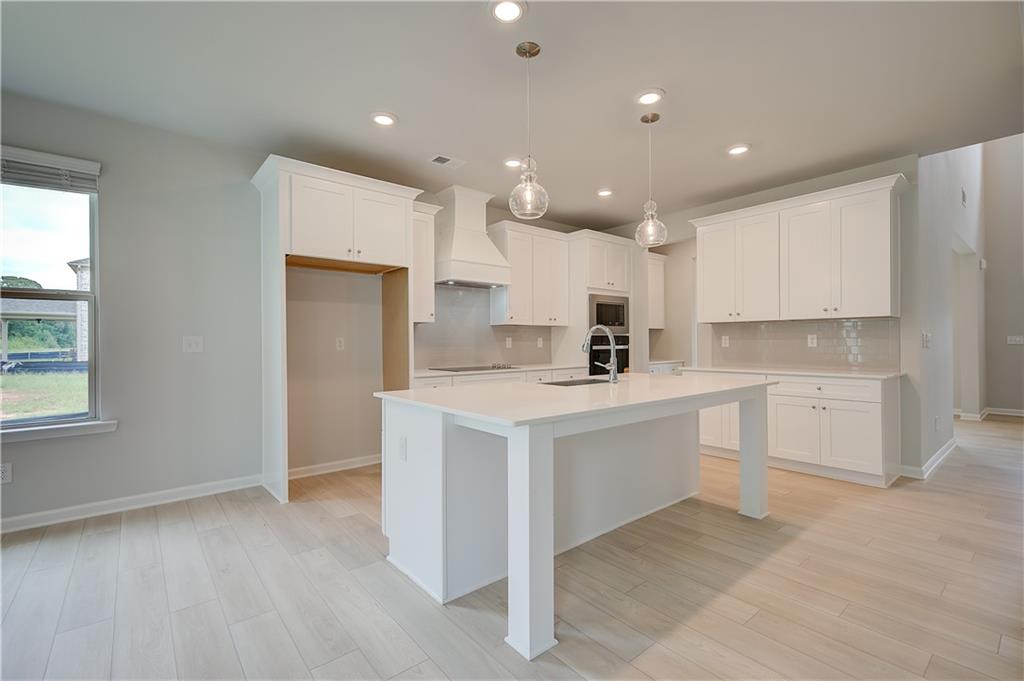 343 Linford Drive Locust Grove, GA 30248 - Photo 11 of 36 a kitchen with a sink a counter top space stainless steel appliances and cabinets