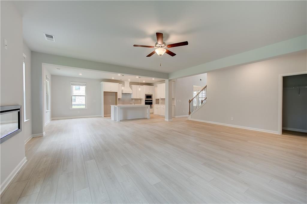 343 Linford Drive Locust Grove, GA 30248 - Photo 16 of 36 a view of empty room with wooden floor and fan